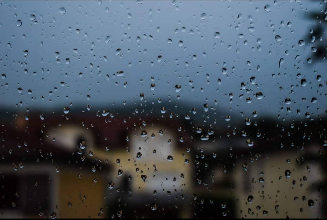 Photo d'un paysage de gap flouté par une vitre remplie de gouttes d'eau. Pour une activité intérieure.
